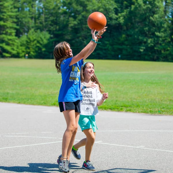 Two girls playing basketball