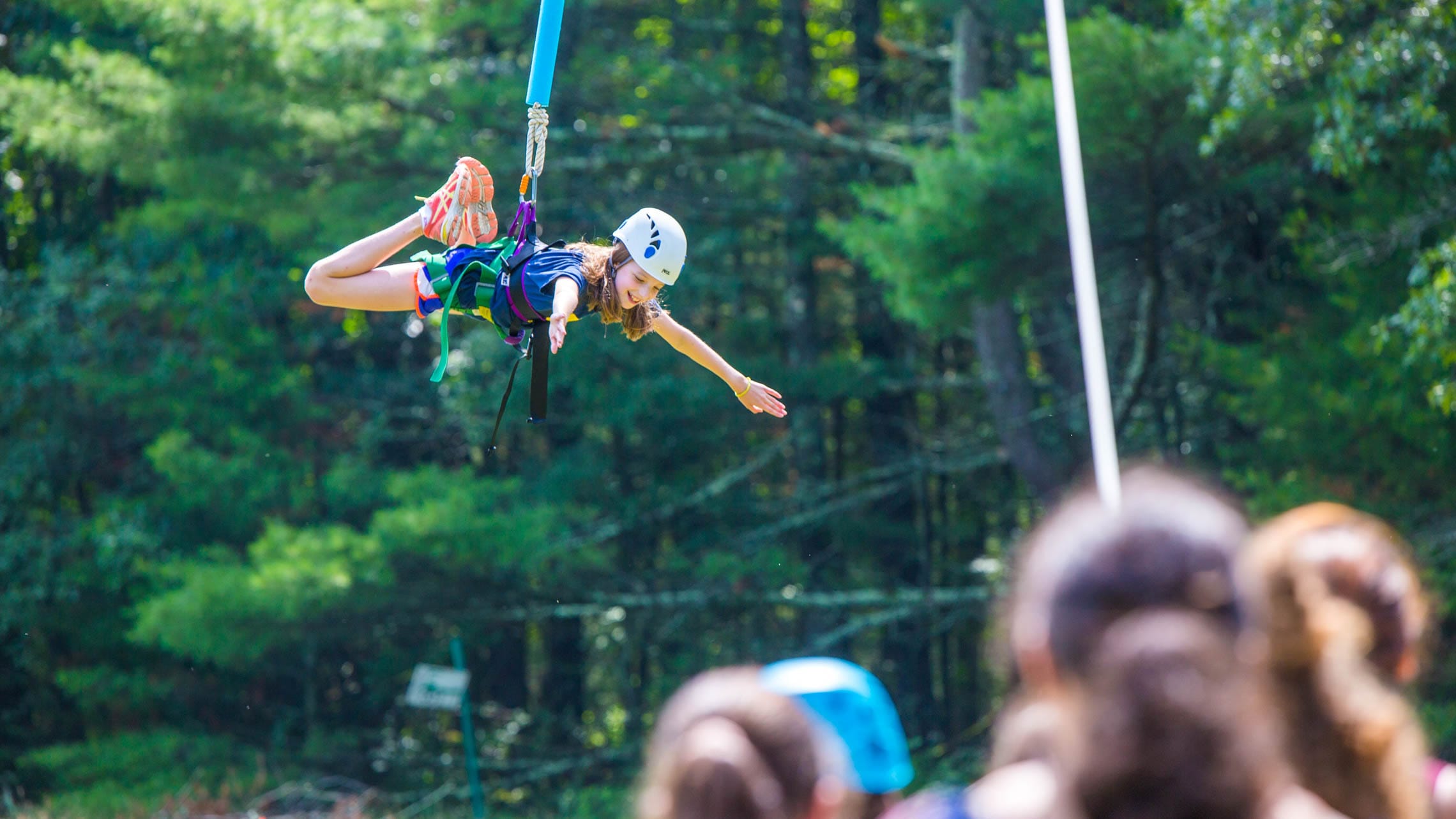 Girl descending from high ropes course